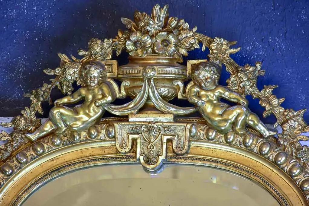 Gilded large Napoleon III mirror with elaborate crest and beveled glass 35½" x 70¾"